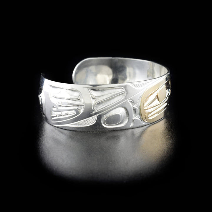 Left angle photo of the bracelet shows carved designs representing one of the eagle's wing and the feathers on it.