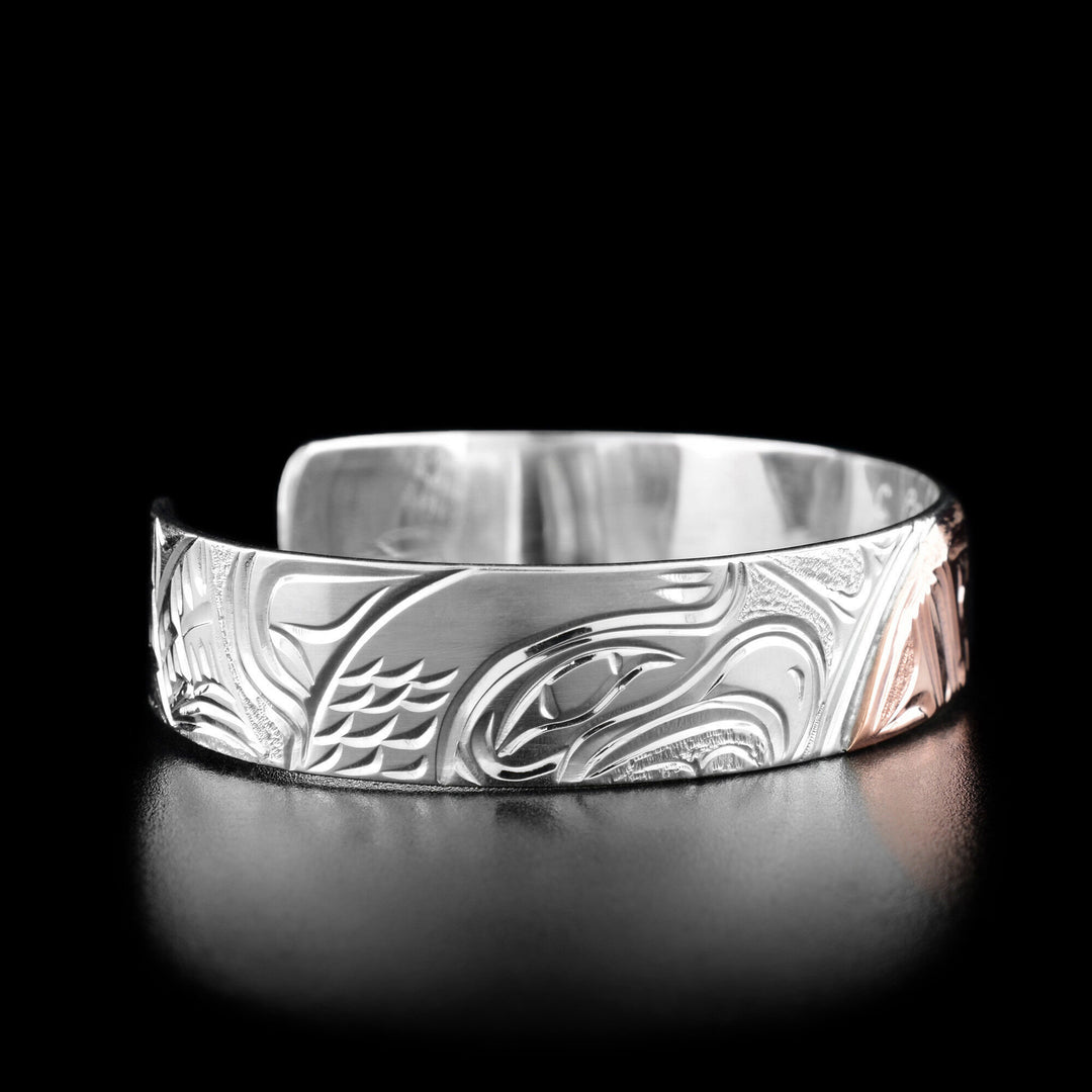 Left angle photo of the bracelet shows the head of an eagle and its feathers facing right towards the moon.