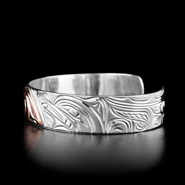 Right angle photo of the bracelet shows the head of a wolf and its body facing left towards the moon.