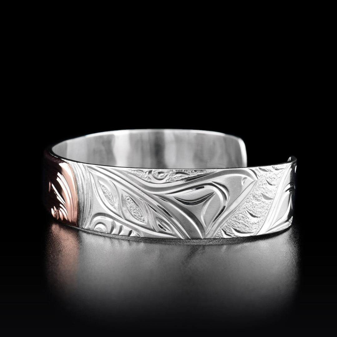 Right angle photo of the bracelet shows the body and fin of the center orca and a third fin of another orca.