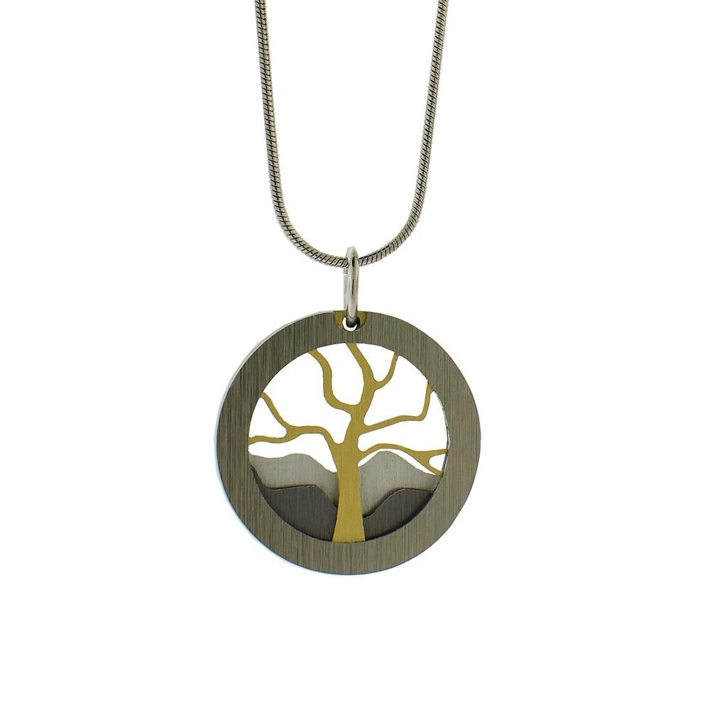 This layered tree pendant necklace has been hand crafted by artist J.R. Franco. He has used brushed and anodized aluminium before being strung on a stainless steel chain. The pendant features a layered, cutout depiction of a tree which is golden colored due to the anodizing of the metal.
