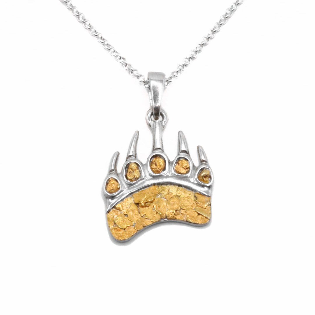 22K Gold Nugget bear paw pendant by Tom Gregorczyk. The pendant is in the shape of a large bear's paw with pointy claws. The artist has placed 22k gold nuggets in each paw-pad as well as the center of the paw. The rest of the pendant is made from sterling silver.