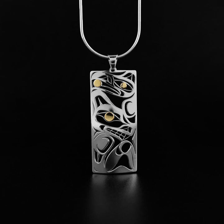 This Raven and Wolf pendant is made from sterling silver and 18K gold with a rectangle shaped. There are cutout depictions of the Raven and the Wolf made in the pendant and the eyes of the Legends are made with 18K gold.