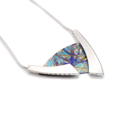 Asymmetrical Turquoise Titanium Necklace by Jean-Yves Nantel. Anodized turquoise titanium in a triangular shape in the center with two asymmetrical sterling silver accents on either side of the titanium.