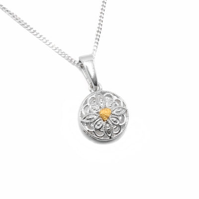 22K Gold Nugget Filigree Pendant by Tom Gregorczyk. The pendant is in the shape of a round filigree with a 22k gold nugget in the center of the pendant.