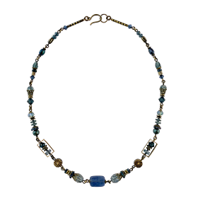 This funky blue gemstone bead necklace is made from brass, freshwater pearls, faceted glass, dumortierite and kyanite. The beads are different shapes and sizes and run along the entire brass chain bracelet.