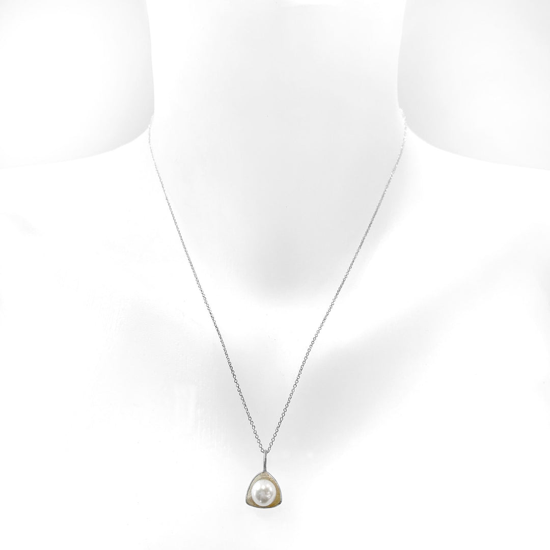 This silver pearl necklace is made from sterling silver and freshwater pearl with a small triangular pendant.