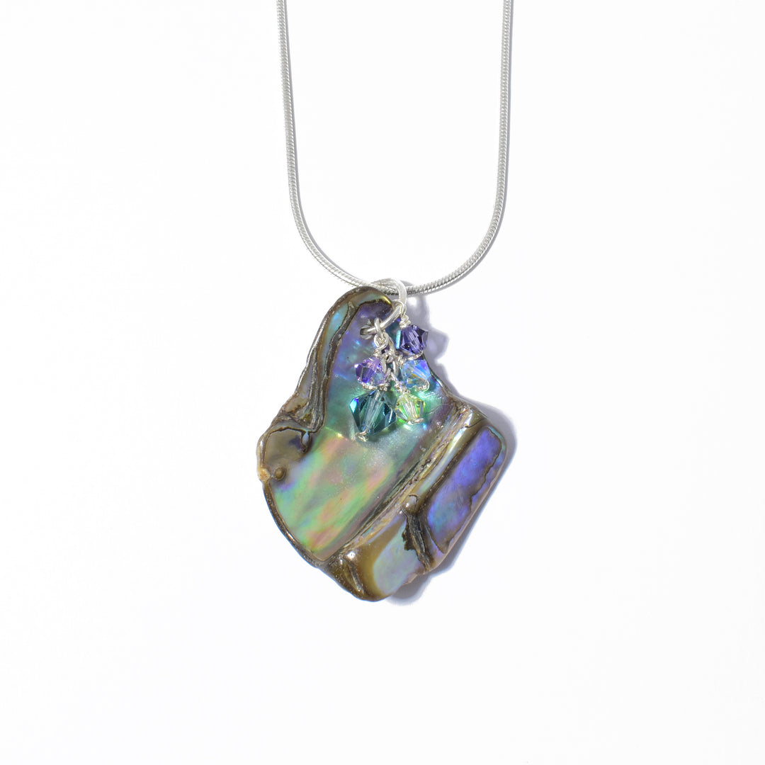 Unique Abalone and Swarovski Crystal Pendant handcrafted by artist Debra Nelson. Made of sterling silver, Swarovski Crystal and abalone. Pendant measures 1.63" x 1.25" including bail. Chain not included.
