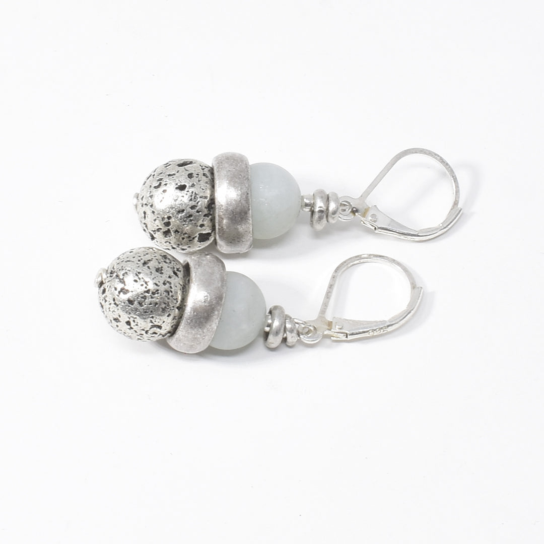 Unique lever back earrings handcrafted by artist Karley Smith. She has used antique silver and matte aquamarine to create them. The ear hooks are sterling silver. Each earring measures 1.55" x 0.50" including hook.