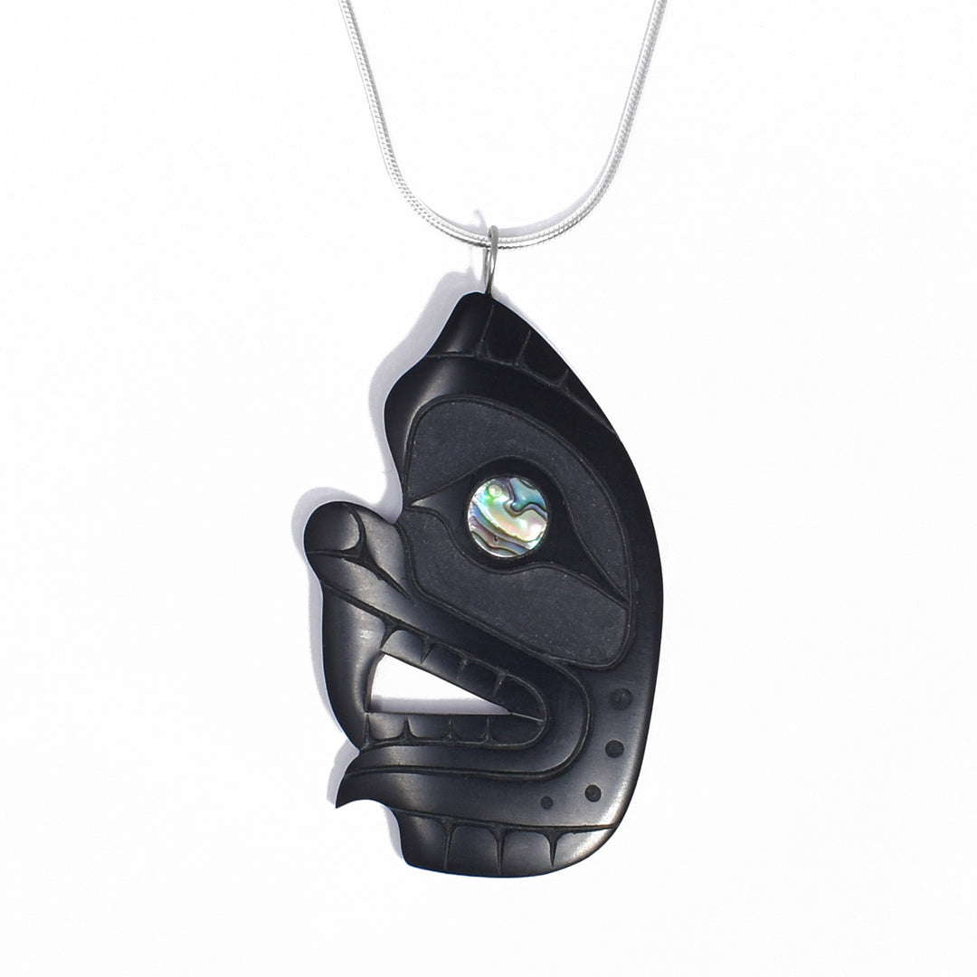 Side view of a grizzly bear’s head with an open mouth. Abalone accent in eye. Pendant measures 2.50” x 1.38” including bail.
