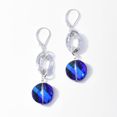 Stunning Bermuda Blue and Cosmic Oval Crystal Earrings handcrafted by artist Debra Nelson. Made of sterling silver, Bermuda Blue Swarovski Crystal and Cosmic Swarovski Crystal. Each earring measures 2" x 0.50" including hook.