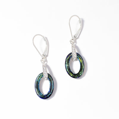 Dazzling Swarovski crystal lever-back earrings handcrafted by artist Debra Nelson. Made of bermuda blue Swarovski crystal, sterling silver and cubic zirconia. Each earring measures 1.50" x 0.44" including hook.