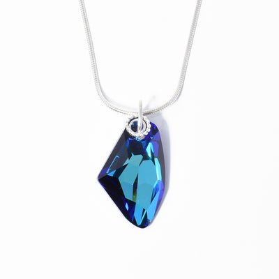 Dazzling Bermuda Blue Galactic Pendant handcrafted by artist Debra Nelson. Made of sterling silver and Bermuda Blue Swarovski Crystal. Pendant measures 1.13" x 0.63" including bail. Chain is not included.
