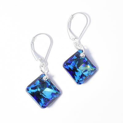 Delicate Bermuda Blue Princess Cut Earrings handcrafted by artist Debra Nelson. Made of sterling silver and Bermuda Blue Swarovski Crystal. Each earring measures 1.38" x 0.56" including hook.