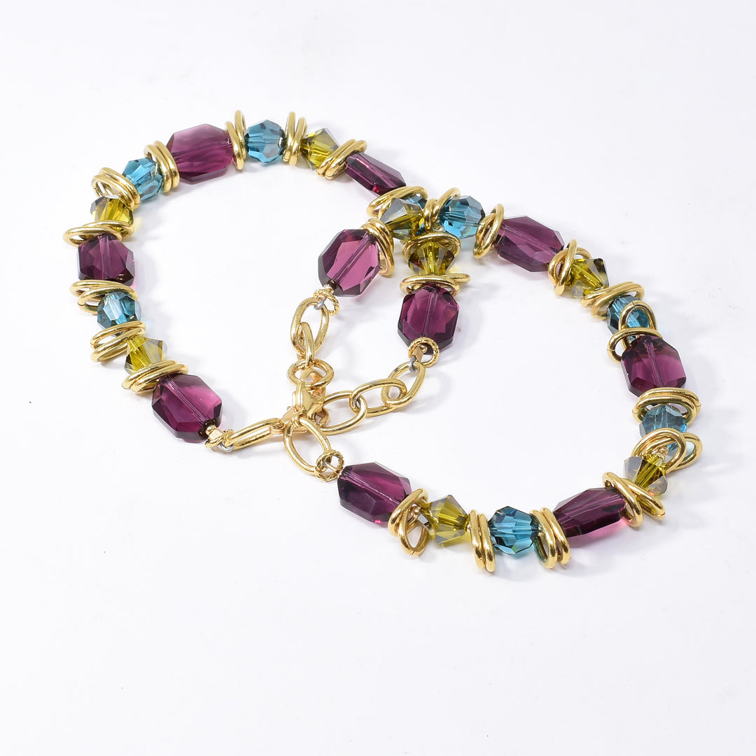 Blue, Green and Purple Swarovski Crystal Bracelet handcrafted by artist Karley Smith. She has used Swarovski Crystal, gold-plated rings and gold-filled finishings to create this bracelet. Swarovski crystals are in the colours: Indicolite Satin, Lime Satin and Amethyst. Bracelet is 7.5" long with 0.5" extender.