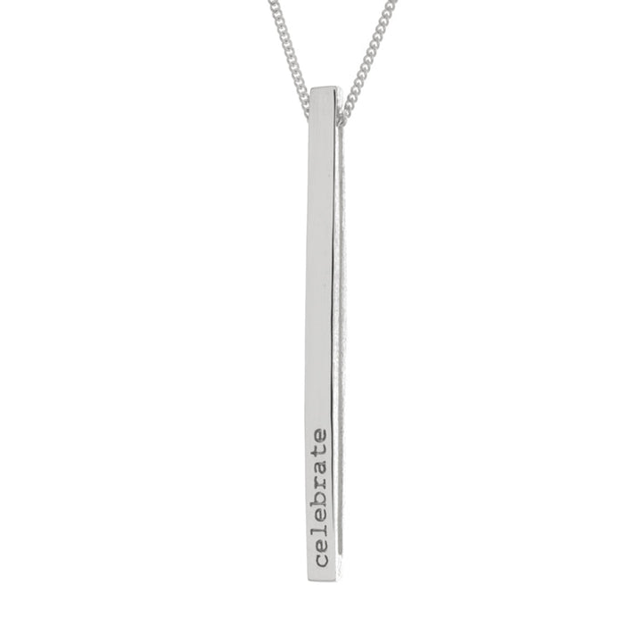 This pendant sterling silver necklace has a long, thin and rectangular pendant. On one side of the pendant is marked "Celebrate" and the other "Discover". The mantra pendant can be flipped to read either message.
