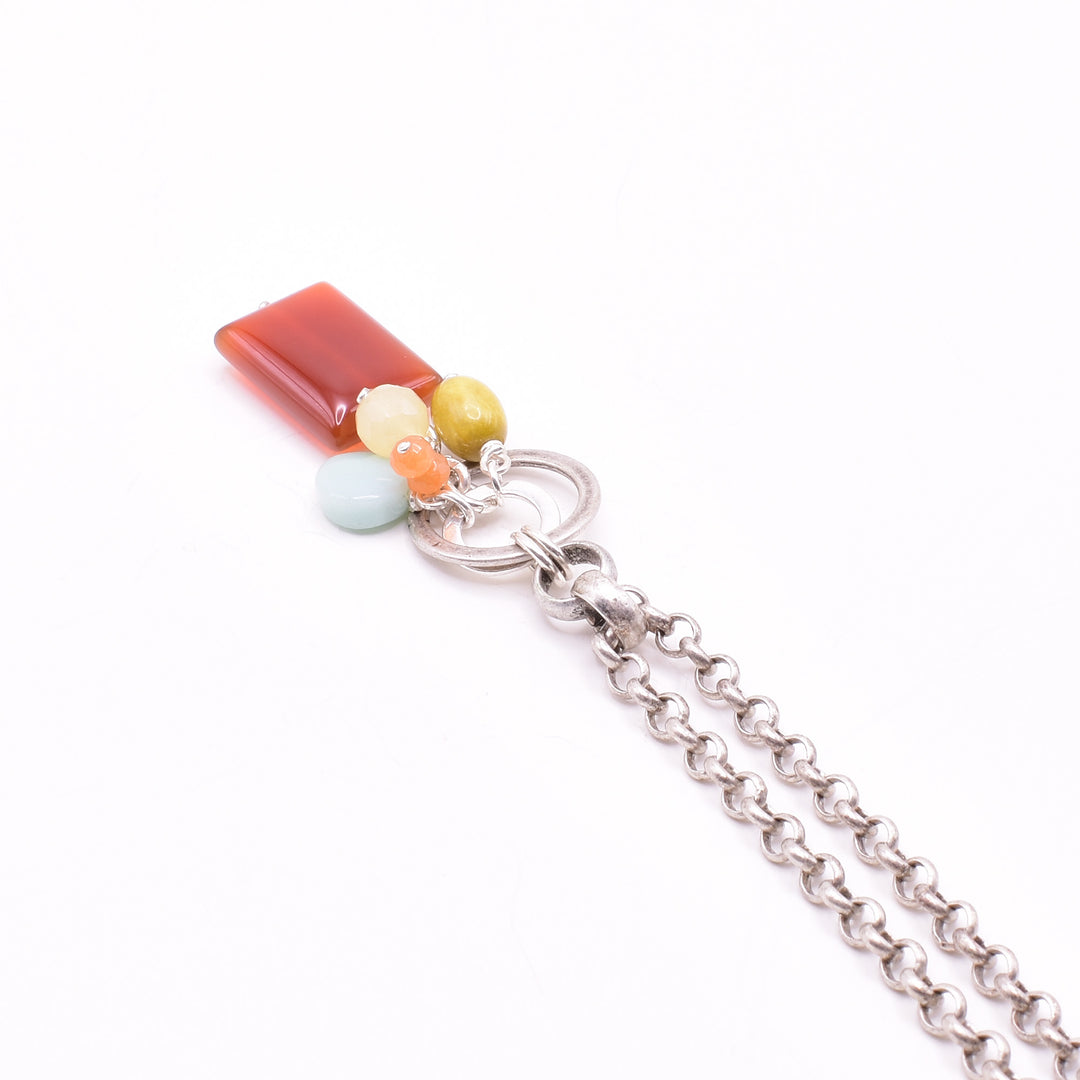 Colourful Gemstone Cluster Pendant Necklace handcrafted by artist Karley Smith. Pendant made of sterling silver, antique silver, carnelian agate, yellow jade, turquoise and amazonite. Antique silver chain included. Pendant measures 2.15" x 0.60" including bail and chain is 24" long.