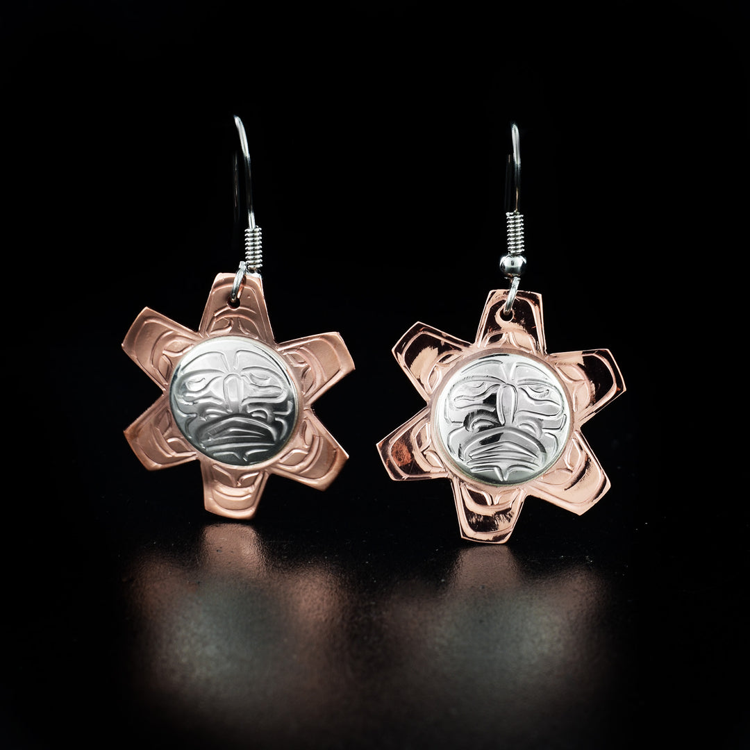 Unique Copper and Silver Sun Earrings hand-carved by Kwakwaka'wakw artist John Lancaster. Made of sterling silver and copper. Each earring measures 1.65" x 1" including hook.