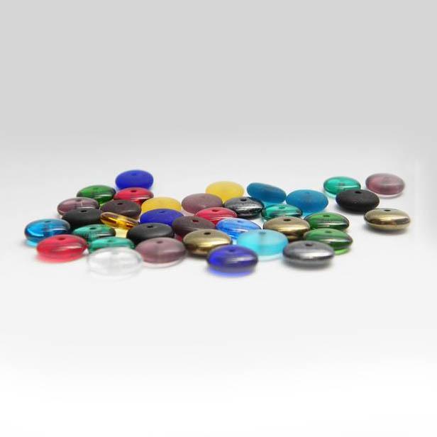 These bead hoop earrings are made from sterling silver and glass beads. The silver hoops curve below the ear and you can interchangeably add up to three colorful beads to each earring