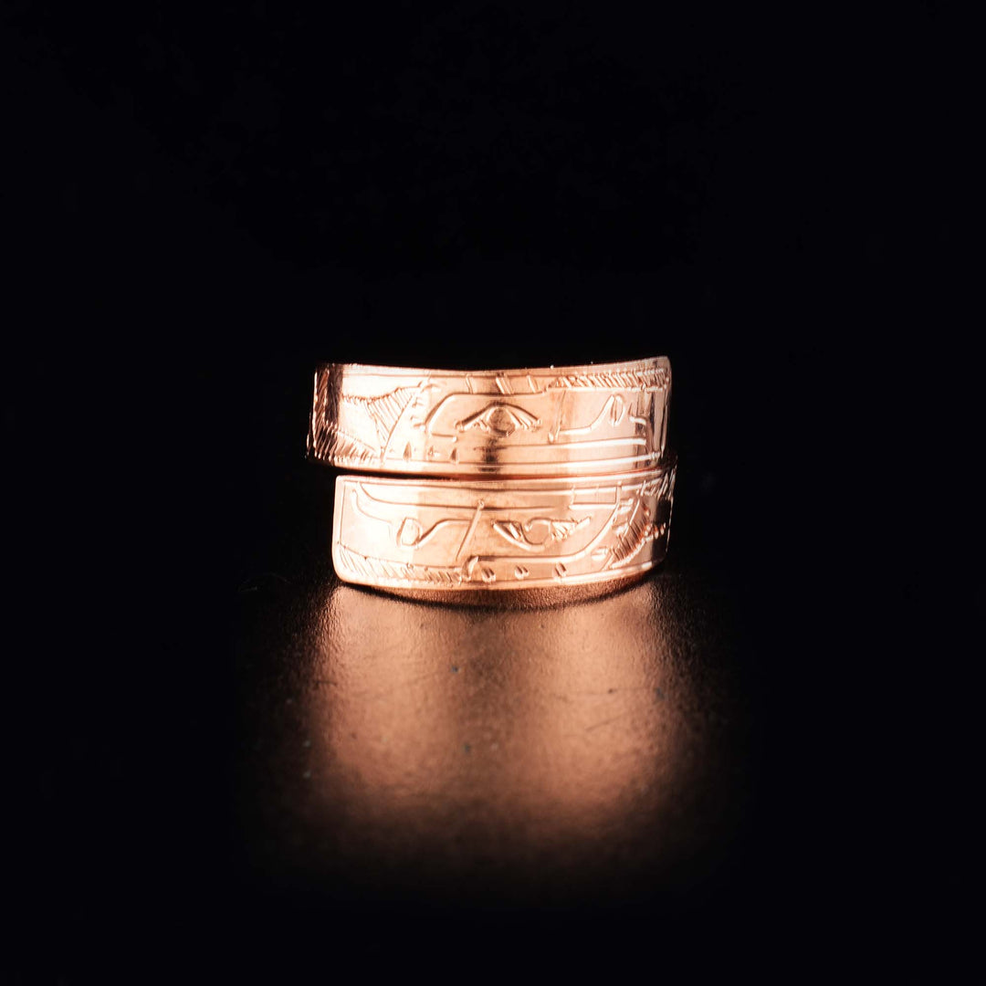 This unique copper ring has a single, thin band that wraps around the finger twice. There are gorgeous depictions of the Eagle that have been carved into the surface of the band.