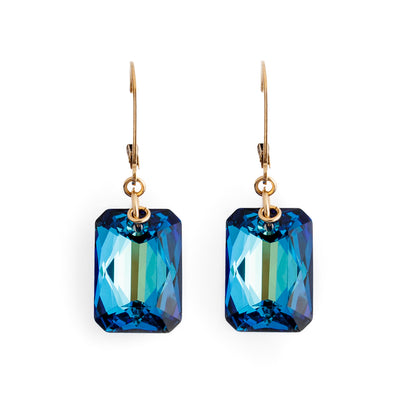 Dazzling lever back earrings handcrafted by artist Debra Nelson. Made of Bermuda Blue Swarovski Crystal and 14K gold-filled hooks and links. Each earring measures 1.44" x 0.50" including hook.