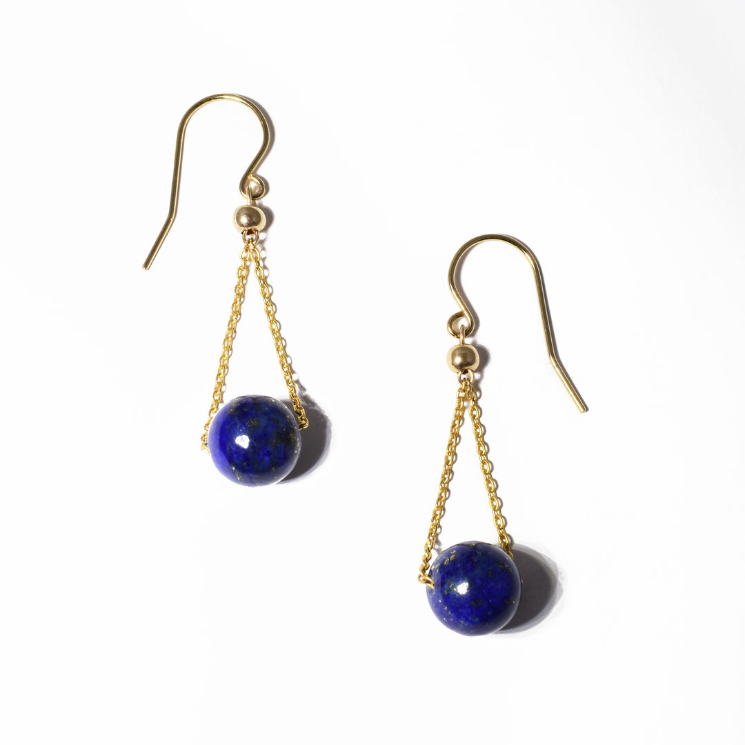 These dangling lapis earrings are made from 14K gold fill and lapis lazuli gemstones. The lapis spheres have gold chains running through them giving them a chandelier appearance.