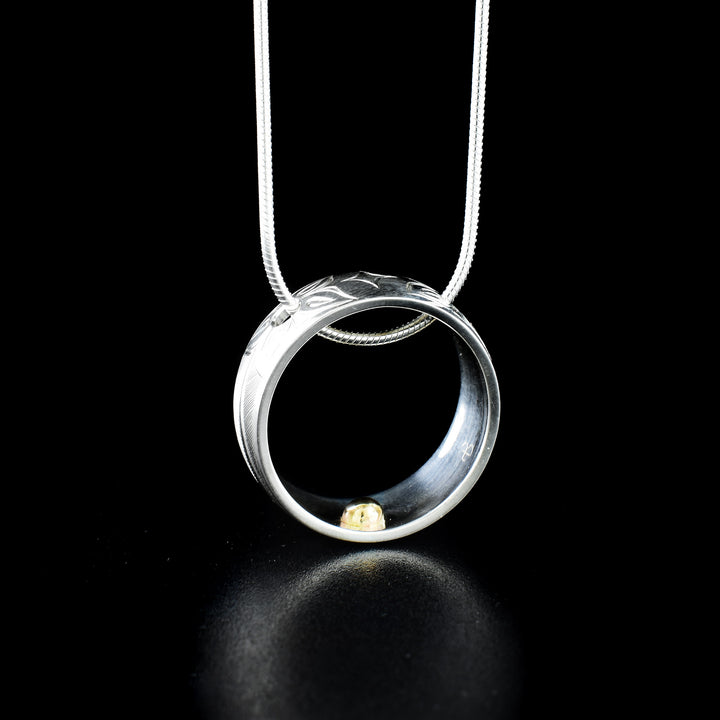 Hummingbird ring pendant hand-carved by Haisla artist Hollie Bartlett. Made of sterling silver and 14K gold. Width of band is 0.38". Can be worn as either ring or pendant. Size 9.