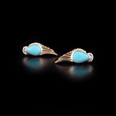 Stunning Gold and Silver Turquoise Wing Stud Earrings handcrafted by artist Dennis Kangasniemi. Made of sterling silver, 14K gold and turquoise. Each earring measures 0.81" x 0.31".