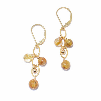 Stunning lever back earrings handcrafted by artist Debra Nelson. Ear hooks and wire are 14K gold fill and beads are golden rutilated quartz. Each earring measures 1.50" x 0.44" including hook.