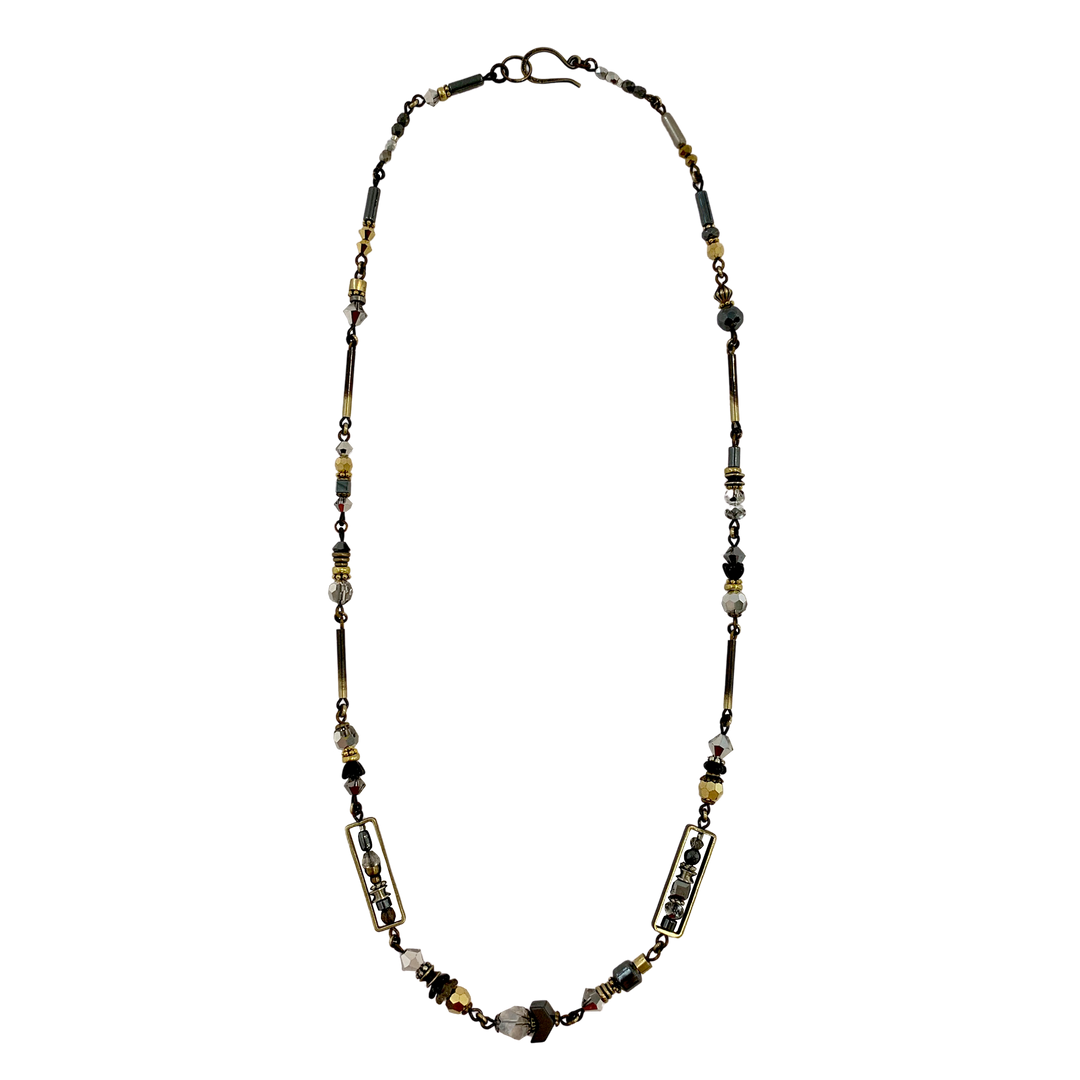 This unique crystal bead necklace is made from hand worked brass, glass, hematine and Austrian crystals. The chains and attachments are made form brass and the necklace is made form unique beads of serval different materials and shapes. 
