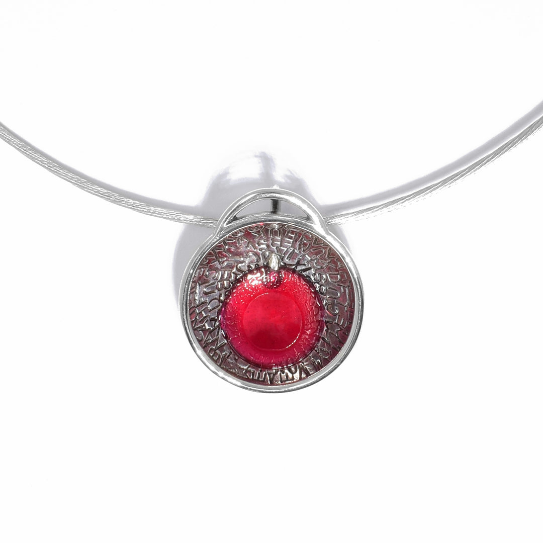 Pendant is drop of hot pink resin in silver bowl, letter-stamped inside. Pendant catches ambient light, giving resin a vibrant glow, which imparts colour onto letter-stamped silver. Adjustable 16” to 18” sterling silver chain included.