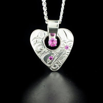 Hummingbird Cut Out Heart Pendant with Pink Stones hand-carved by Coast Salish and Cree artist Richard Lang. Made of sterling silver and lab-created pink stones. Pendant measures 1.38" x 1.13" including bail. Chain not included.