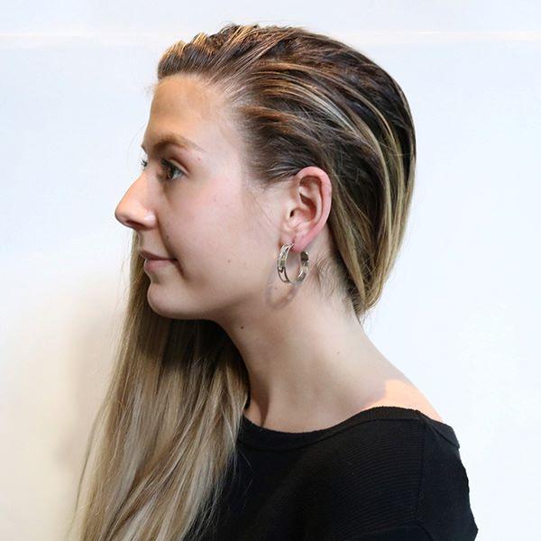 This sterling silver hoop earrings have cutout designs on the surface of the hoops that depict the Orca.