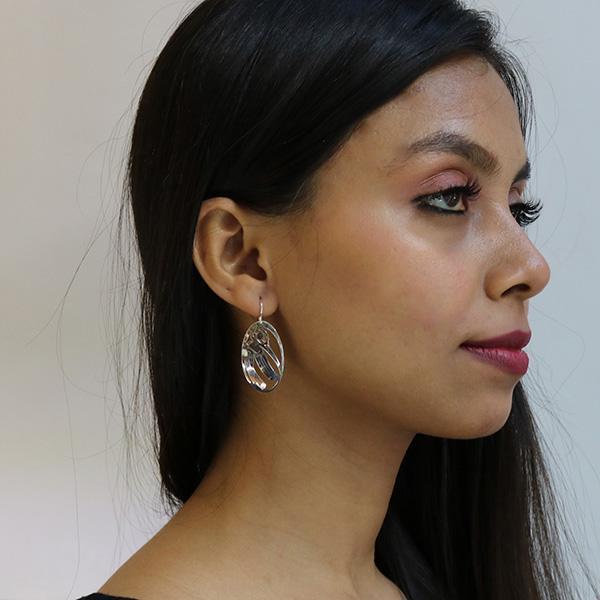These Hummingbird earrings are made form sterling silver and have oval shaped hangs. There are cutout designs on the surface of the hangs that depict the Hummingbird.