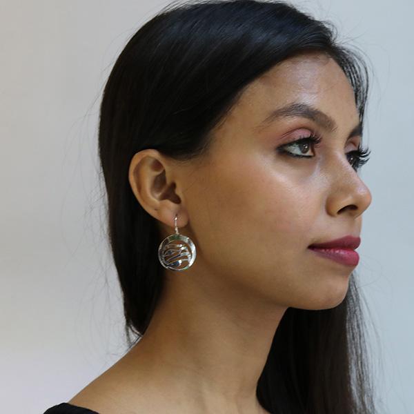 These dangling Eagle earrings are made from sterling silver and have circle shaped hangs. There are cutout designs on the hangs that depict the Eagle.