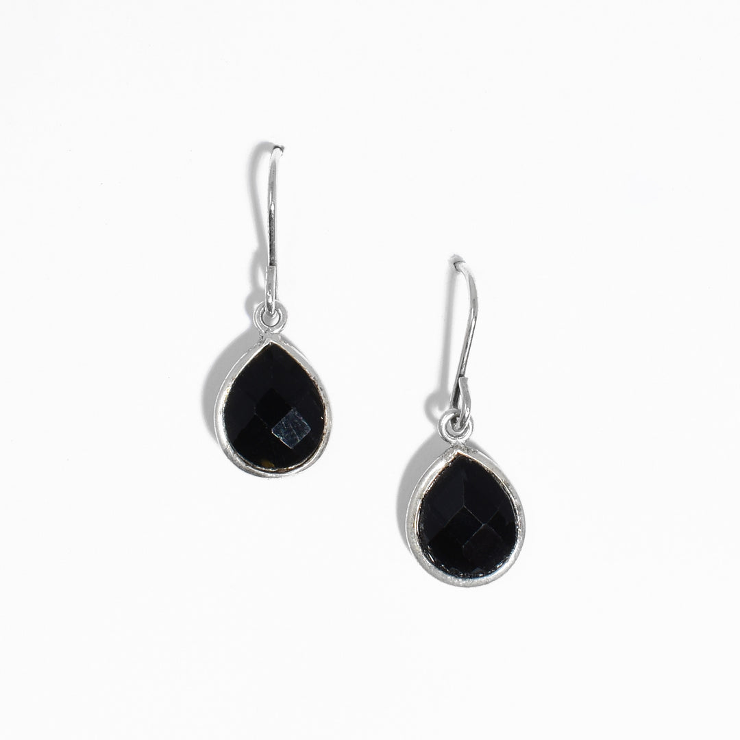 Petite sterling silver teardrop onyx dangle earrings. Onyx framed by sterling silver. 1" x 0.38" including hooks.