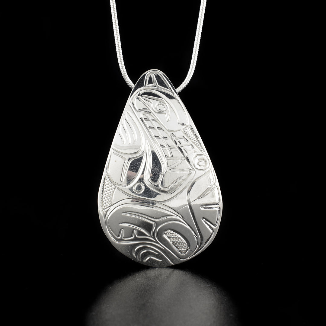 Large Sterling Silver Teardrop Wolf Pendant hand-carved by Kwakwaka'wakw artist Norman Seaweed. Pendant measures 2" x 1.1". Hidden bail on back. Chain not included.
