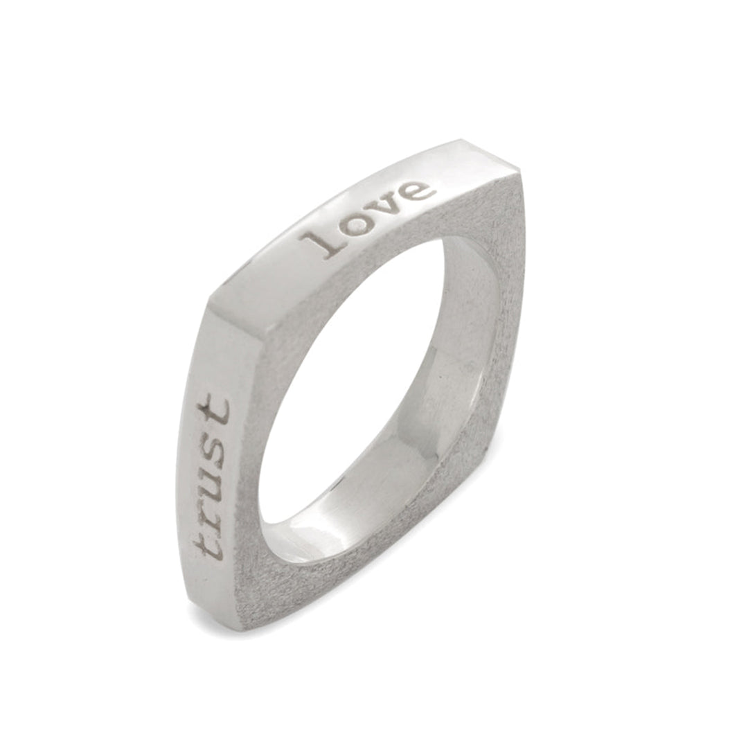 This mantra square ring is made from sterling silver and has a thin, square shaped band. There are affirmations written on each side of the band reading: love, trust, value and respect.