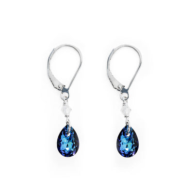 Dainty lever back earrings handcrafted by artist Debra Nelson. Made of Bermuda Blue Swarovski Crystal, clear Swarovski Crystal and sterling silver. Each earring measures 1.25" x 0.25" including hook.