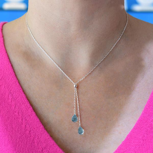 This silver gemstone necklace is made from sterling silver with two faceted, blue topaz hanging down together.  The necklace is approximately 18" long, and the lariat hangs down an additional 1.75" (4.7cm).