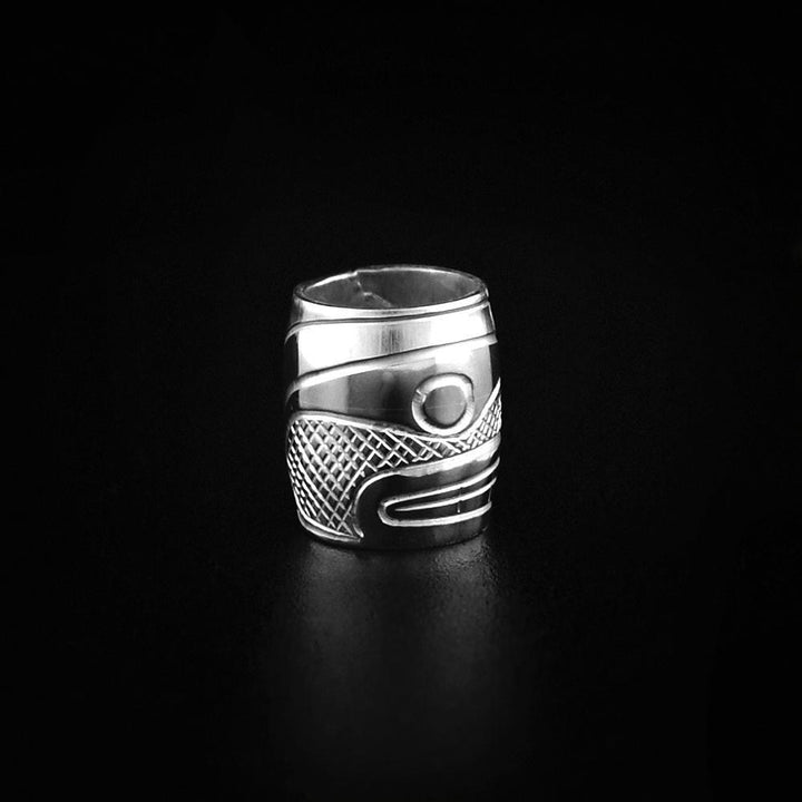 This Orca whale charm is made from sterling silver and is longer than is it wide. There is a depiction of the Orca carved into the surface of the bead.