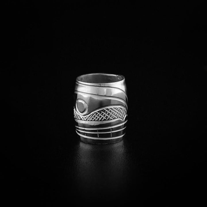 This Orca whale charm is made from sterling silver and is longer than is it wide. There is a depiction of the Orca carved into the surface of the bead.