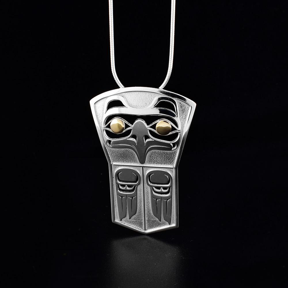 This Eagle pendant is made form sterling silver, 18K gold and has a shield shape. There are cutout depictions of the Eagle on the pendant and its eyes are made from 14K gold.