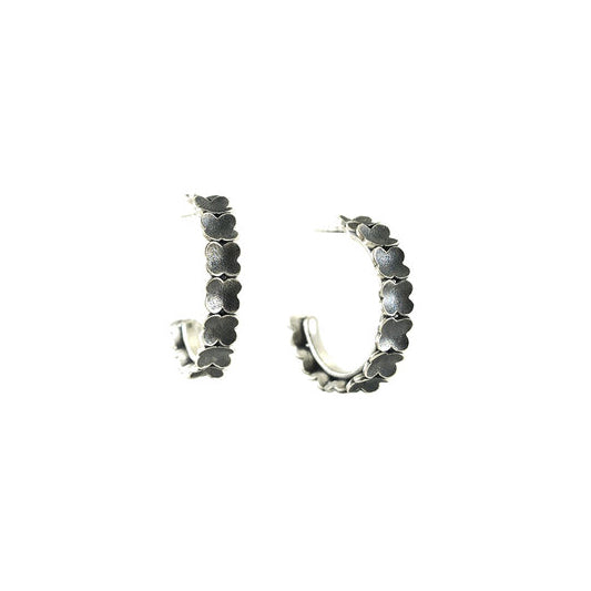 Oxidized Silver Floral Half Hoops handcrafted by artist Dushka Vujovic. She used sterling silver to create them and oxidized the flowers. Each earring is approximately 0.19" wide and has diameter of 0.88".