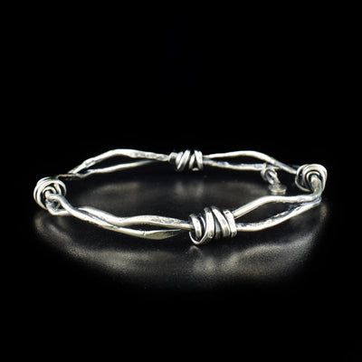 Unique Medium Twist of Fate Bangle handcrafted by artist Joy Annett. Made of oxidized sterling silver. Bracelet has circumference of 9".