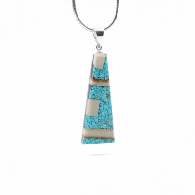 Turquoise and Mammoth Ivory Pendant by Aryn Bowers. Aryn uses fossilized mammoth ivory and pieces of turquoise to create the pendant before setting it on a sterling silver bail.