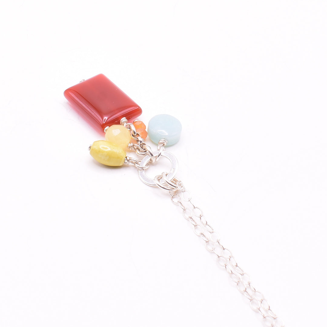 Petite Colourful Gemstone Cluster agate necklace with pendant handcrafted by artist Karley Smith. She has used carnelian agate, yellow turquoise, amazonite, yellow jade and sterling silver to create the pendant. Sterling silver chain included. Pendant measures 1.70" x 0.40" including bails and chain is 20" long.
