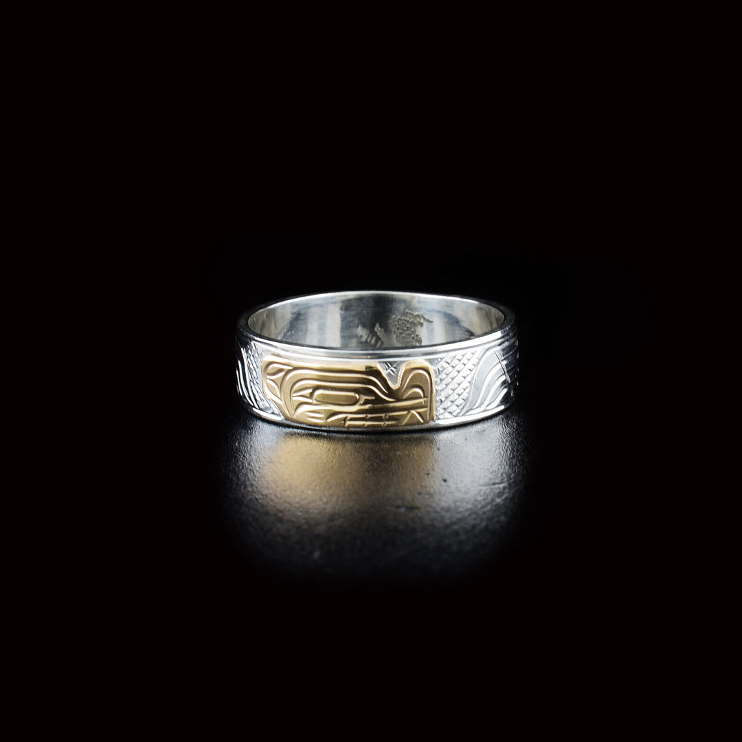This Wolf ring is made from sterling silver and 14K gold and has a single band. There is a depiction of the Wolf carved into the band and the head of the Wolf is made from 14K gold.