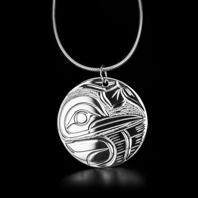 Stunning round hummingbird pendant hand-carved by Kwakwaka'wakw artist Victoria Harper. Made of sterling silver. Pendant measures 1" in diameter. Chain not included.