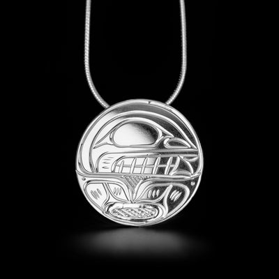 Unique round orca pendant hand-carved by Kwakwaka'wakw artist Victoria Harper. Made of sterling silver. Pendant measures 1" in diameter. Chain not included.